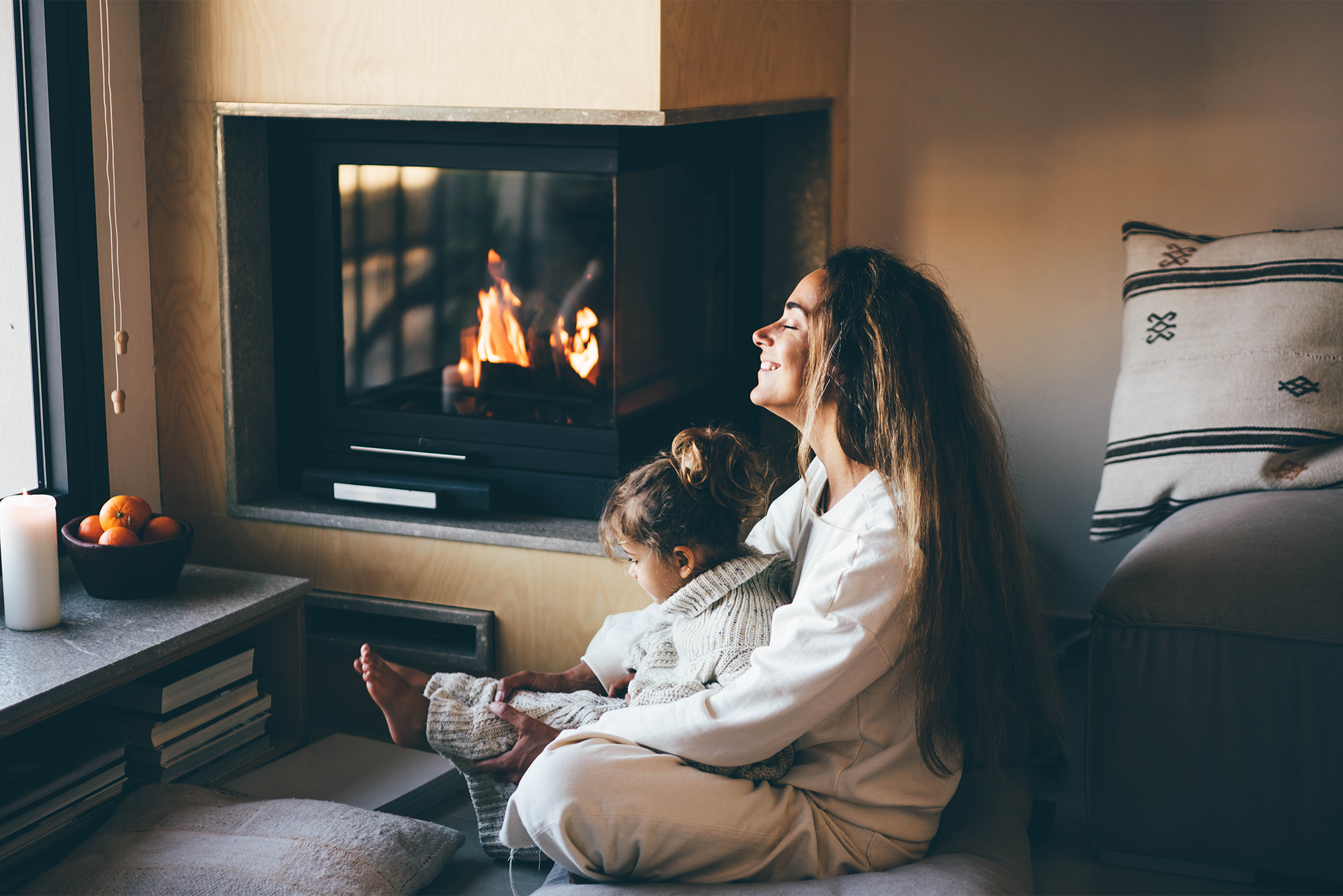 Mom and daughter by the fire