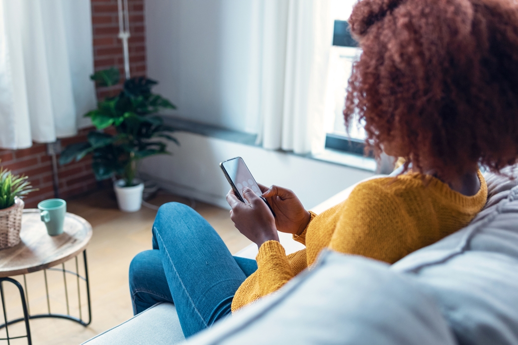 woman on couch using phone