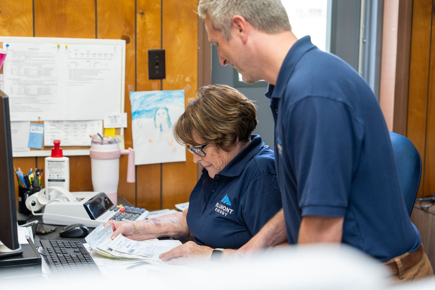 two employees reviewing paperwork