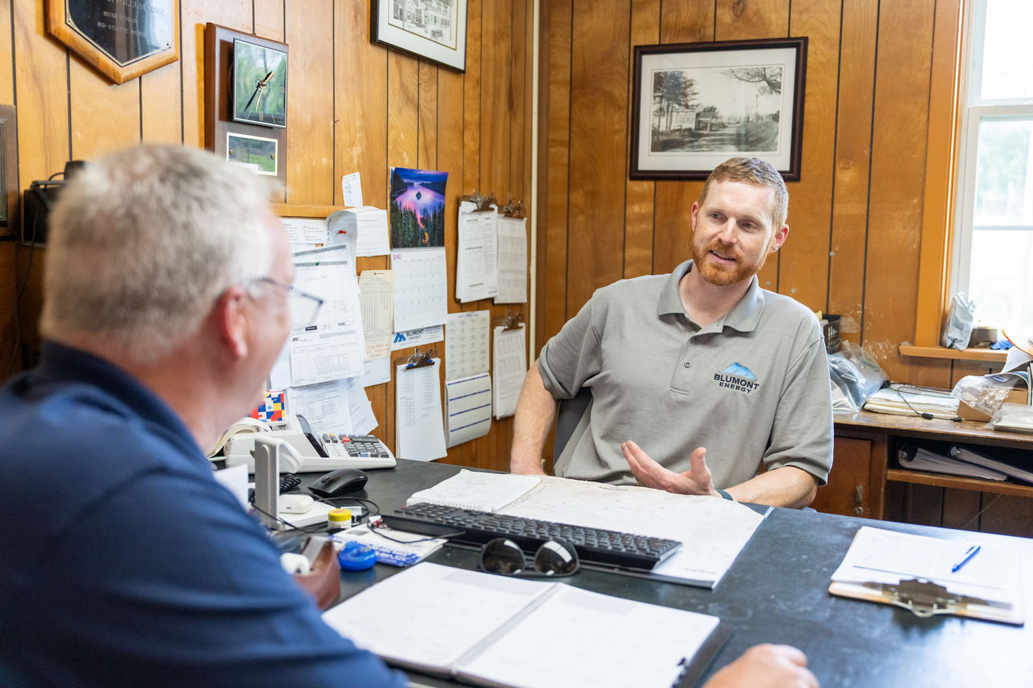 employees at their desk having a conversation