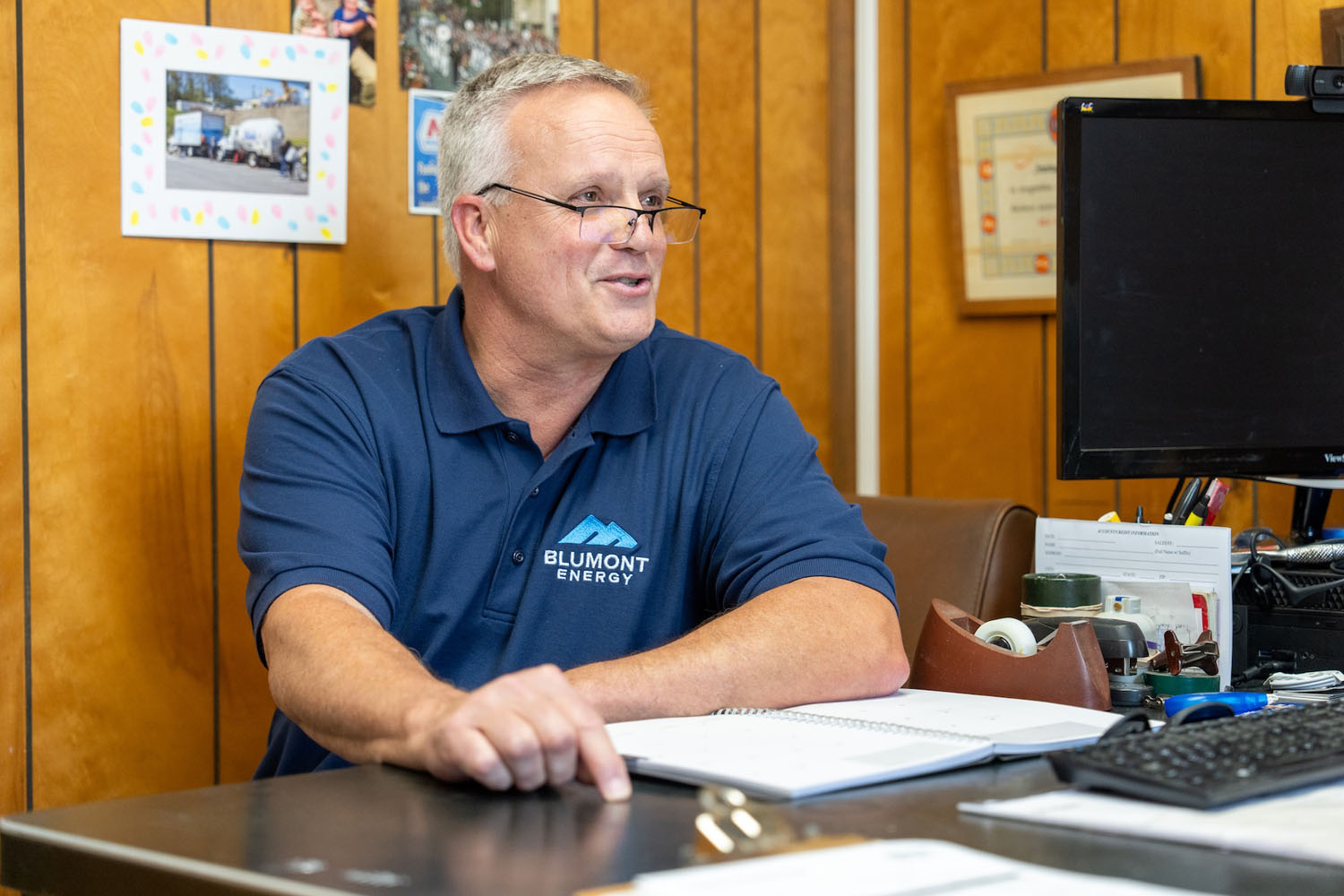 happy employee at their desk talking