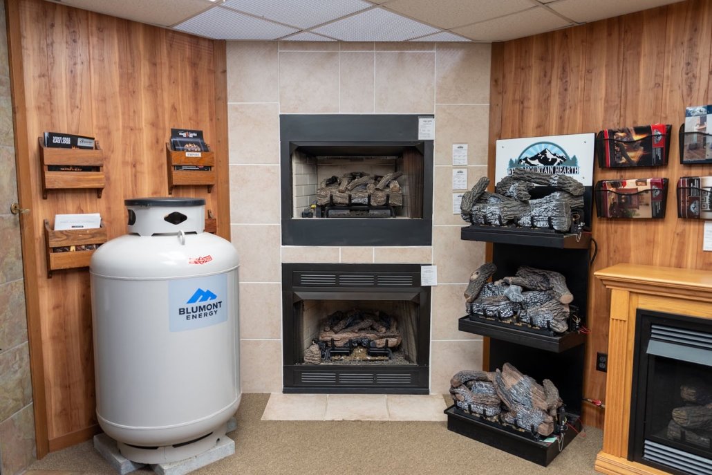Blumont Energy showroom with fireplace log sets and a propane tank