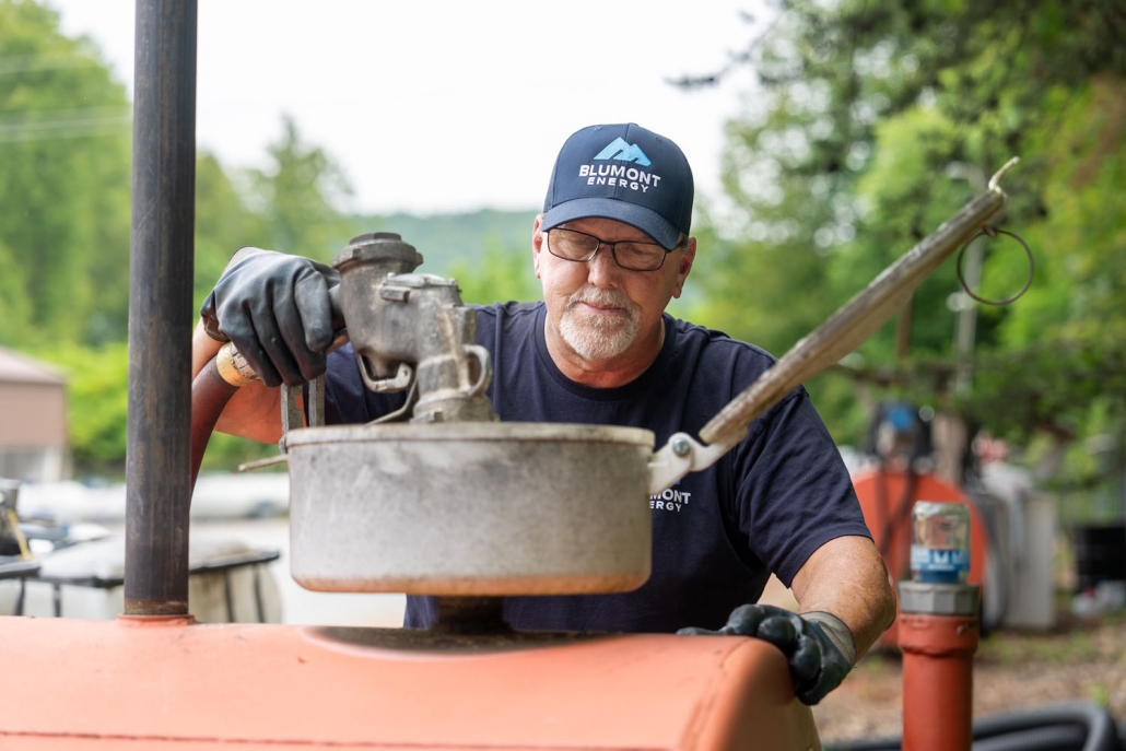 Blumont Energy service technician filling up a tank